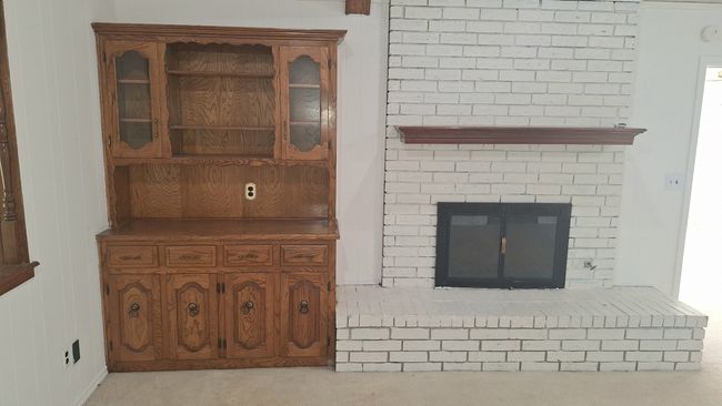 Detailed view of a brick fireplace and built-in hutch | Image 5