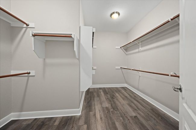 Spacious primary walk-in closet. | Image 22