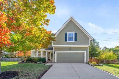 Front facade with a front lawn and a garage | Image 1