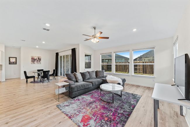 Living area with baseboards, visible vents, recessed lighting, ceiling fan, and light wood-style floors | Image 13