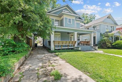 View of front of property featuring covered porch, a front yard, and ceiling fan | Image 2