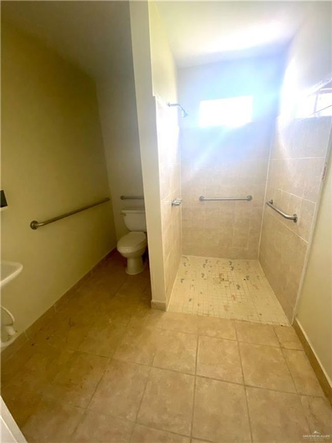 Bathroom with toilet and tile floors | Image 13