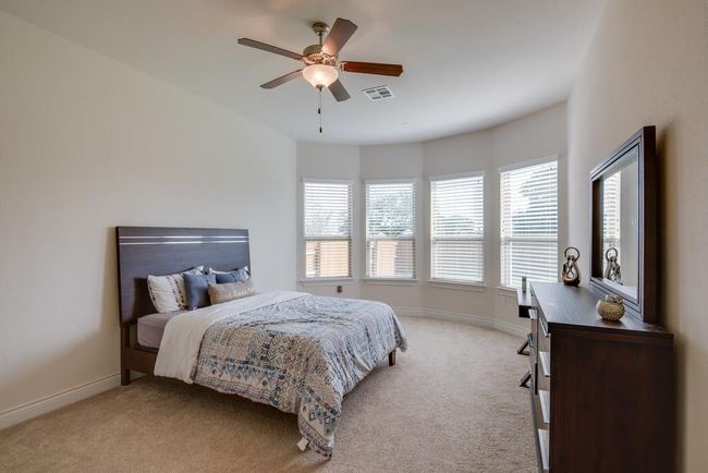 Bedroom with multiple windows, light carpet, and visible vents | Image 15