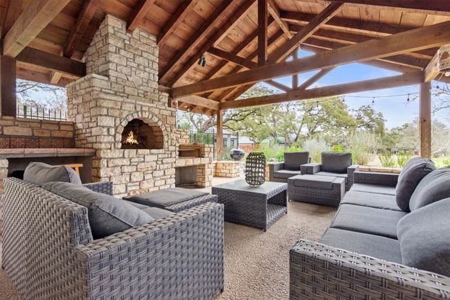 View of patio featuring a gazebo and an outdoor living space with a fireplace | Image 7