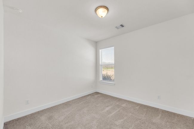 Empty room with light carpet, visible vents, and baseboards | Image 30