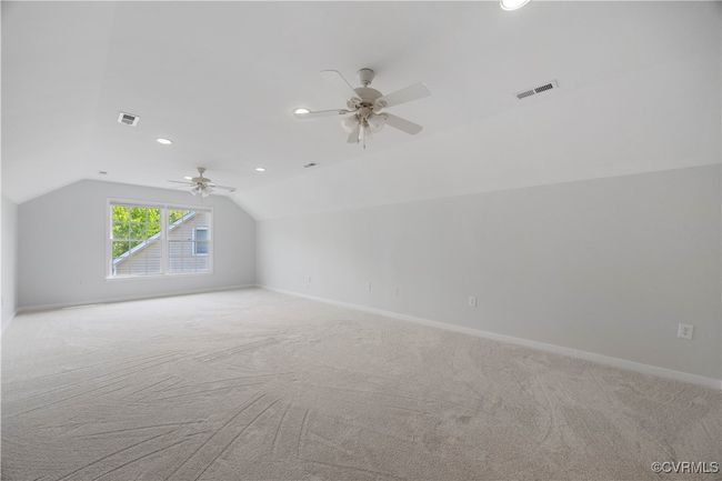 3rd floor bedroom featuring ceiling fan, light colored carpet, and with full bathroom | Image 41
