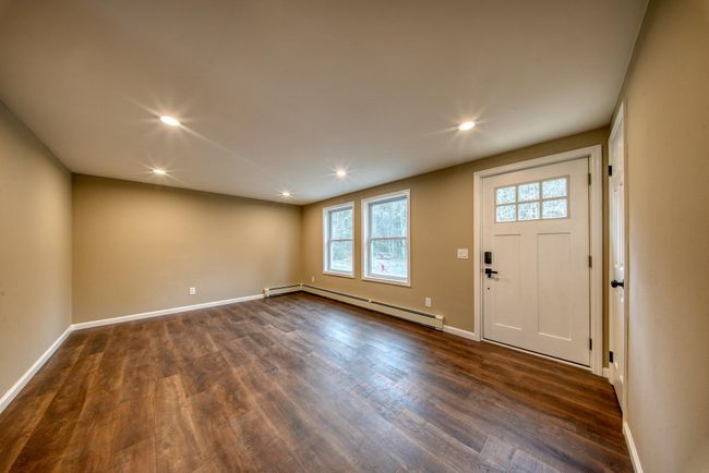 Foyer entrance with recessed lighting, dark wood finished floors, baseboards, and baseboard heating | Image 4