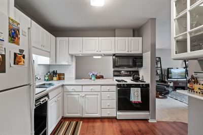 Kitchen with opening to dining | Image 1