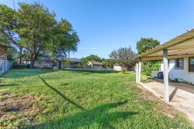 View of yard featuring central AC unit, a patio, and fence | Image 24