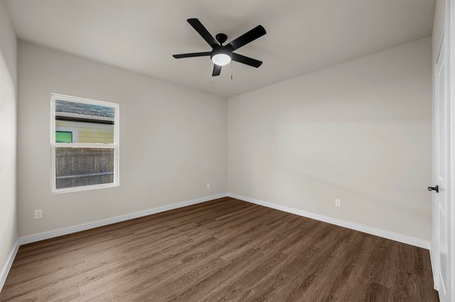 Empty room featuring wood finished floors, a ceiling fan, and baseboards | Image 26