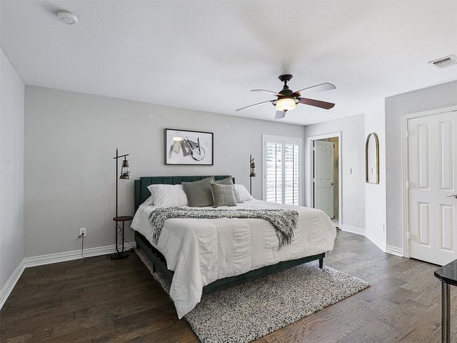 Bedroom with dark wood finished floors and a ceiling fan | Image 29