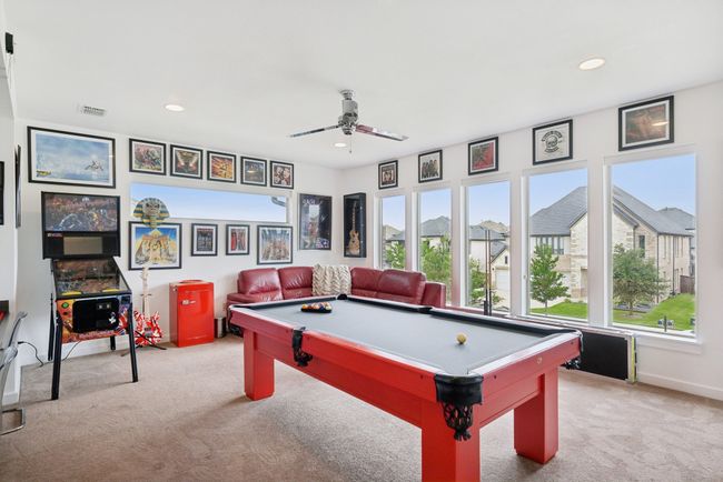 Playroom featuring light carpet, healthy amount of natural light, a ceiling fan, billiards table, and recessed lighting | Image 25