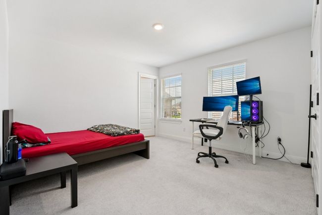 Carpeted bedroom with baseboards and a desk | Image 27