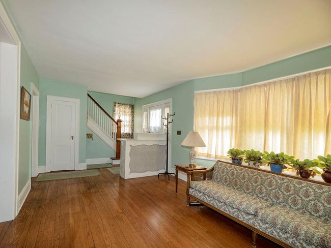Living room with stairway and wood finished floors | Image 13