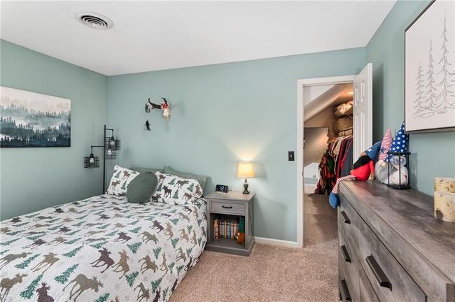 Bedroom with light carpet, a walk in closet, and a closet | Image 24