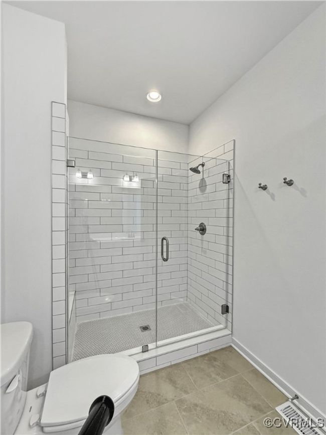 Bathroom with toilet, baseboards, visible vents, recessed lighting, and a shower stall | Image 13