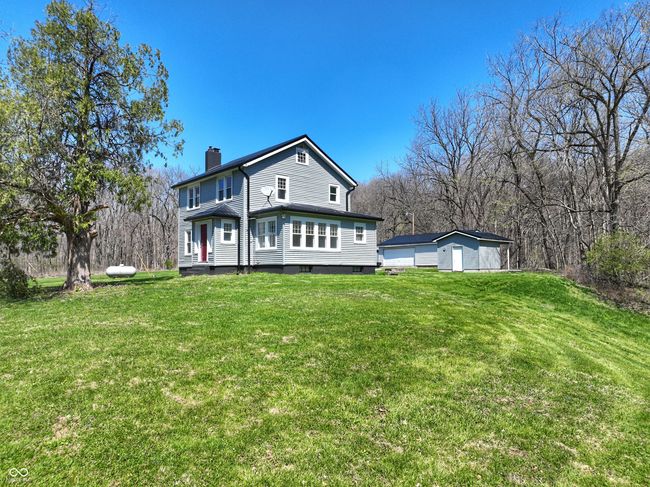 rear view of house with a chimney and a lawn | Image 8