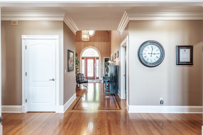 The hardwood floors feature beautiful cherry inlays. | Image 18