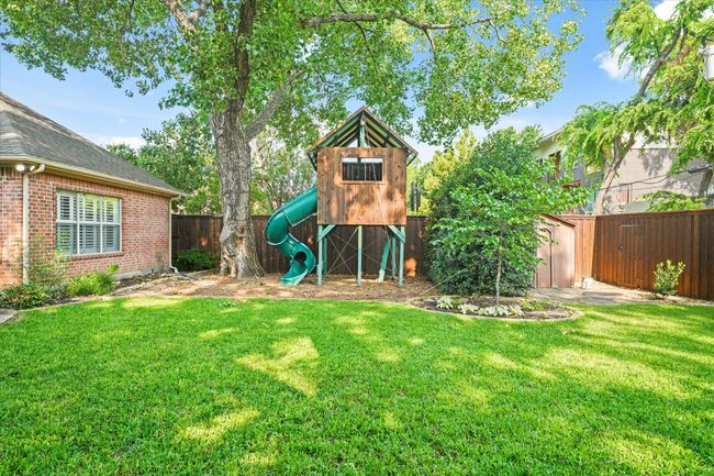 View of yard with a playground and a storage shed | Image 33