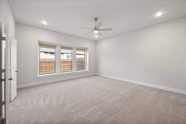primary bedroom with window seat and custom electric woven wood window shades | Image 19