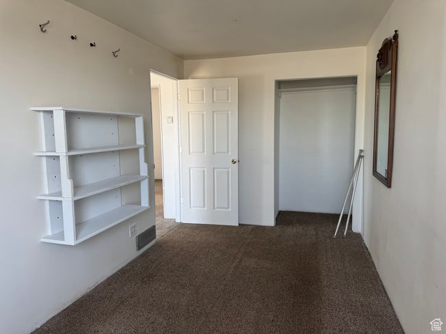 Unfurnished bedroom featuring visible vents, carpet floors, and a closet | Image 32