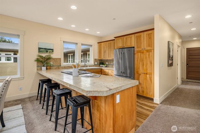The eat-in kitchen offers a seamless transition between spaces, creating an inviting and functional layout. | Image 11
