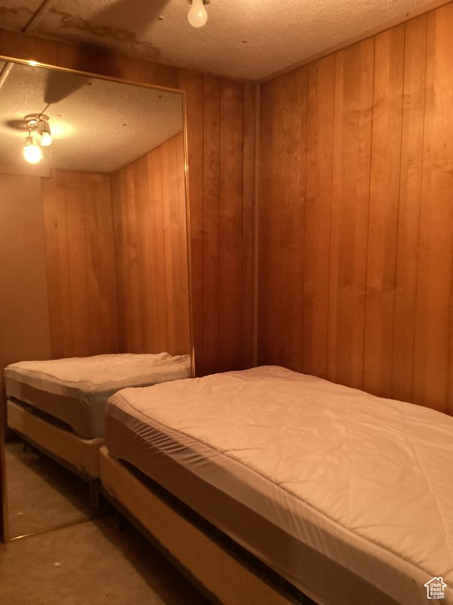 Bedroom featuring wooden walls | Image 19