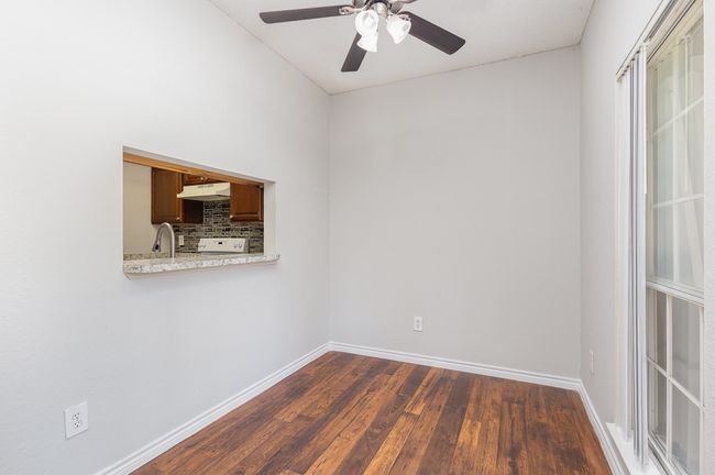 Unfurnished room featuring dark wood-style flooring and ceiling fan | Image 5