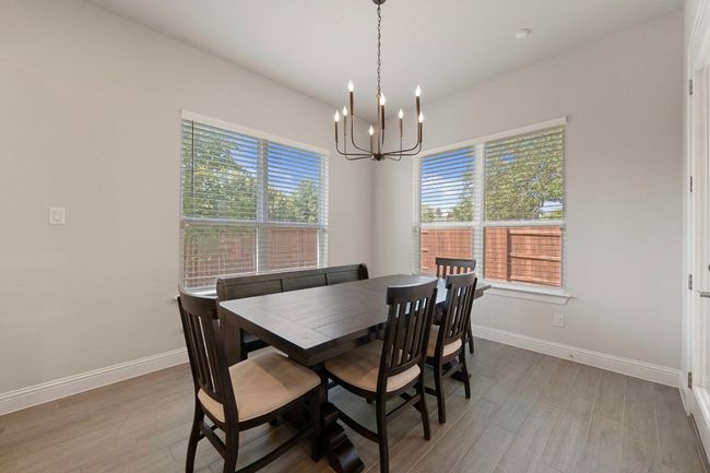 Dining area featuring a chandelier, plenty of natural light, and baseboards | Image 11