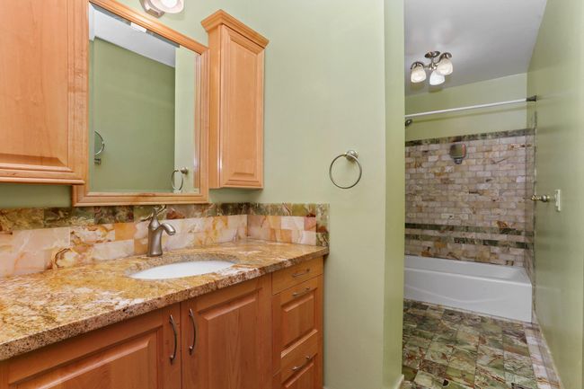 Bathroom with vanity, shower combination, and tasteful backsplash | Image 24