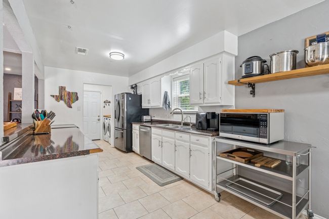 Lots of cabinets & countertops space, and the microwave and stainless steel cart can convey to buyer, if they desire! | Image 11