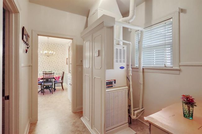 From the kitchen you can pass through a hallway with access to a full guest bathroom and an oversized mud room/utility room. | Image 16
