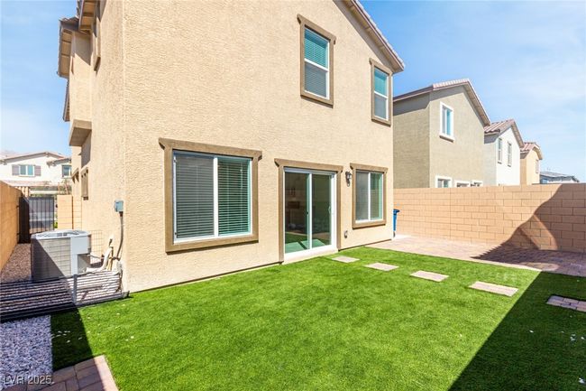 Back of house with a yard, stucco siding, and a fenced backyard | Image 28