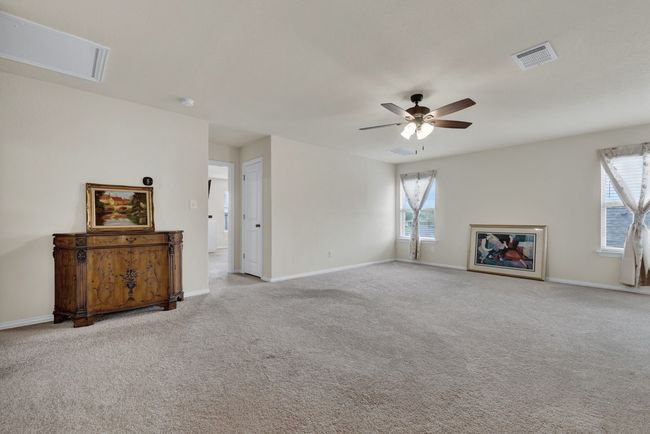 Unfurnished living room with baseboards, carpet flooring, ceiling fan, and visible vents | Image 26