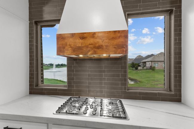 Custom kitchen window allowing for serene lake views all day long | Image 16