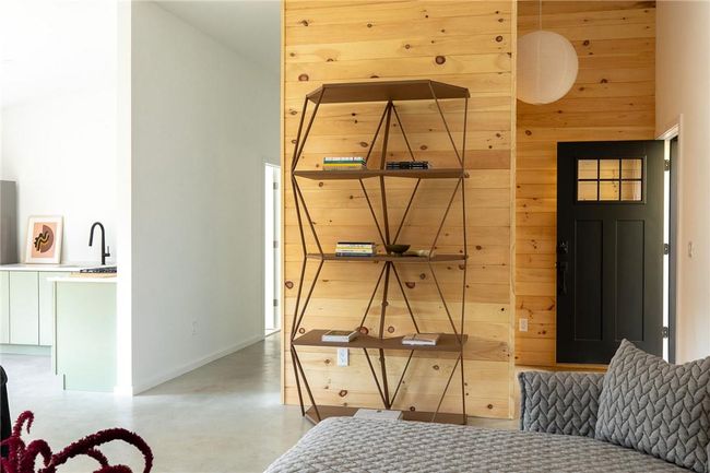 Bedroom with concrete floors and wooden walls | Image 6