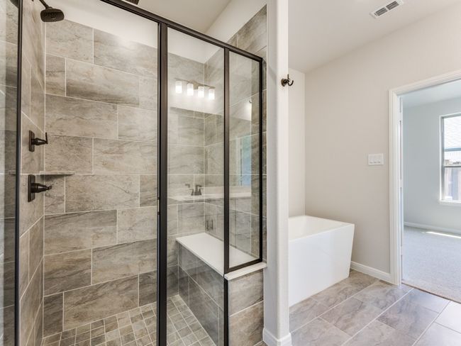 Whether is a long, luxurious shower or soaking your cares away in the freestanding tub, this wonderful owner's bath is the perfect place to start or end your day. | Image 14