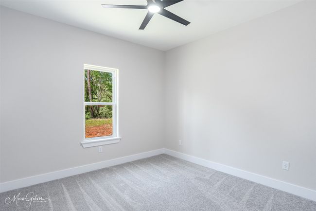 Spare room with a ceiling fan, baseboards, and carpet floors | Image 14