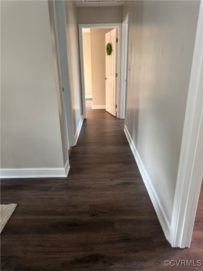 Hallway featuring baseboards and dark wood-style floors | Image 14