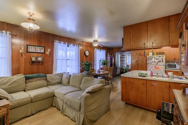 To the Left of the kitchen is your eat-in area. Farther to the right is the sofas of the Family Room. | Image 9