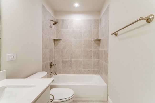 Full bathroom with tiled shower / bath, vanity, and toilet | Image 31