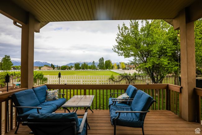 Deck with a mountain view and an outdoor living space | Image 48