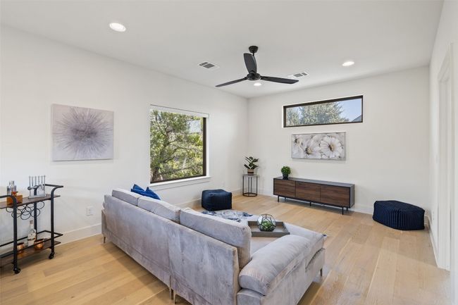Living room with wood-type flooring, visible vents, and a healthy amount of sunlight | Image 24
