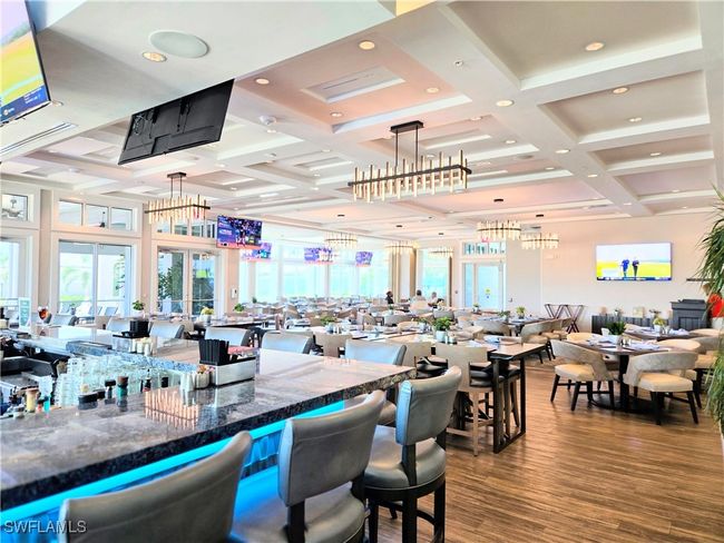 Elegant Dining room with bar featuring coffered ceiling, wood finished floors, healthy amount of natural light, beamed ceiling, and recessed lighting | Image 40