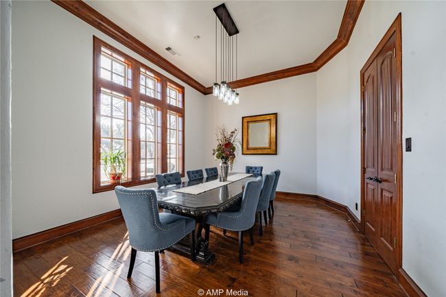 Dining area featuring a wealth of natural light, crown molding, and dark hardwood / wood-style floors | Image 5
