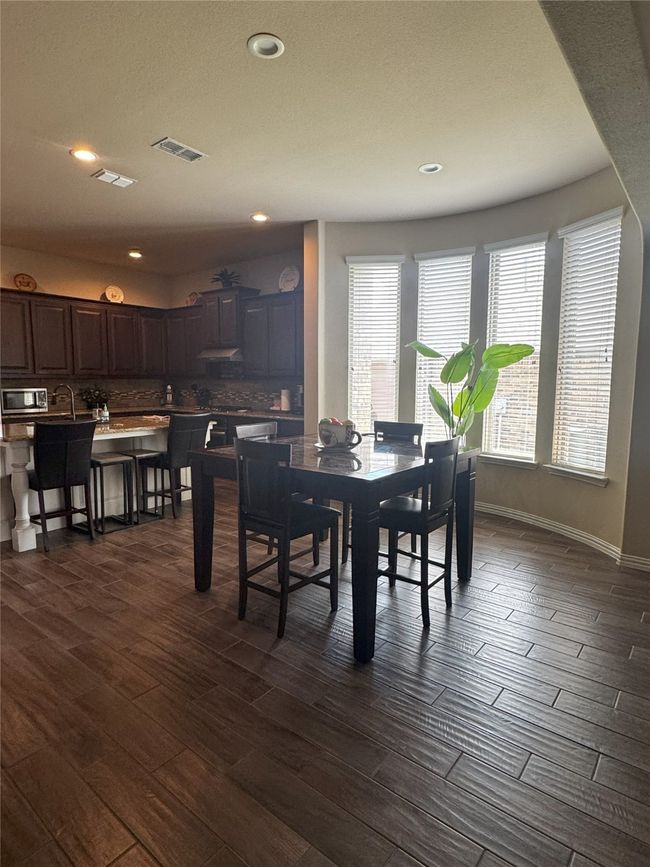 Dining space with dark wood finished floors and recessed lighting | Image 24