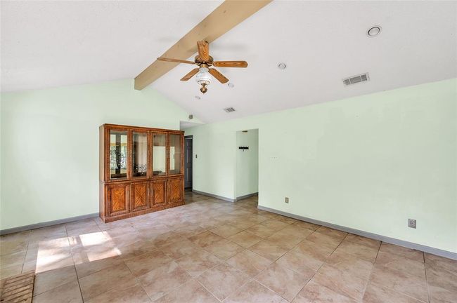 Spacious living room leading seamlessly into the hallway, offering an inviting flow and abundant natural light. | Image 21
