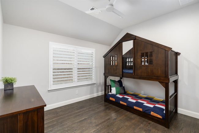 Fourth bedroom is located on the second floor with soaring ceilings, hand scraped hardwoods and plantations shutters. All bedrooms feature walk in closets. | Image 31
