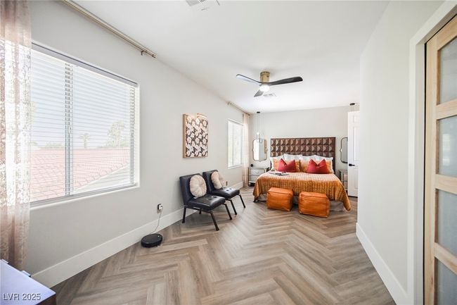 Bedroom featuring baseboards, designed styled flooring and a ceiling fan | Image 52