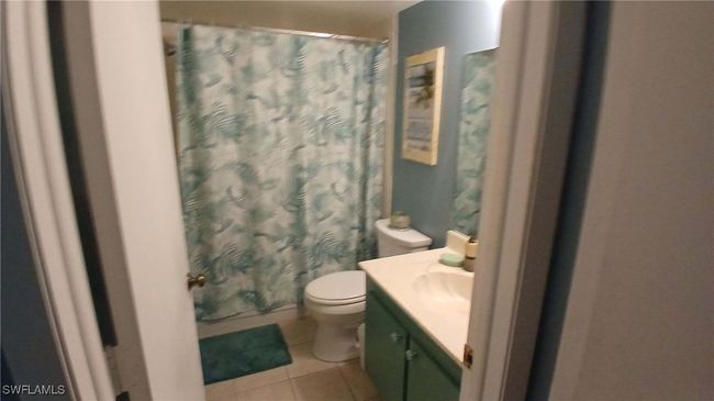 Master Bathroom with tub/shower , patterened floor tile patterned floors, and vanity | Image 6